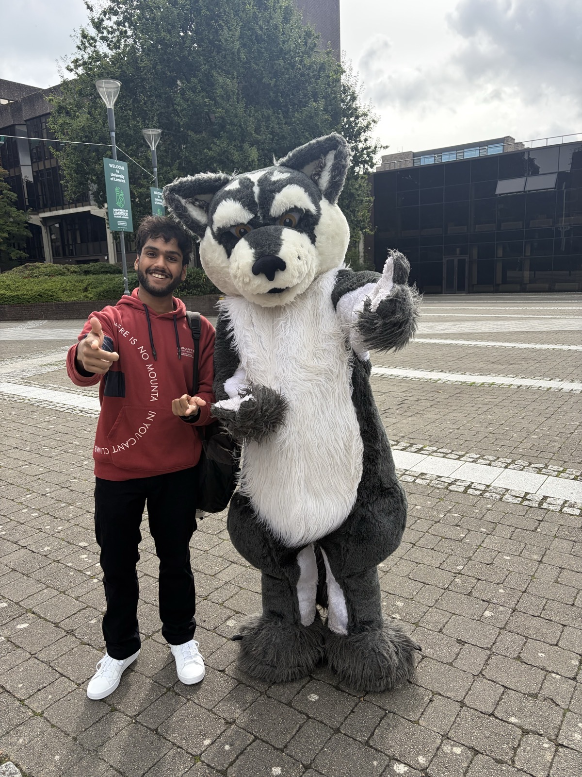 Chirag with Wolfie, the UL Student Life mascot, on campus